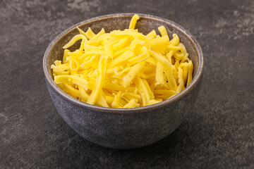 Shredded yellow cheese in the bowl
