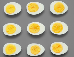 Boiled eggs cut in half on gray background.
