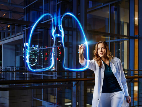 Female pulmonologist light painting lung in laboratory at hospital