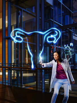 Mature female gynecologist analyzing ovary in laboratory at hospital