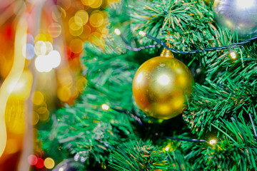 Obraz na płótnie Canvas Closeup of balls in Christmas background with fairy lights on bokeh background