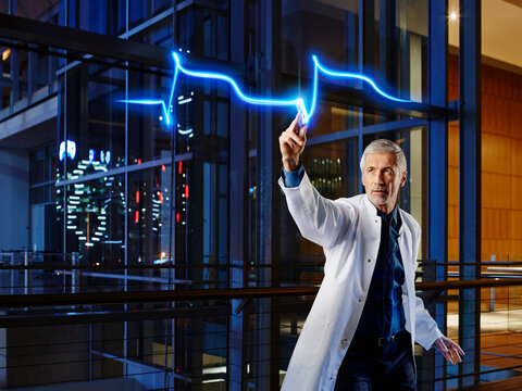Male cardiologist examining heart attack in laboratory