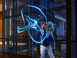 Male internist light painting spleen in laboratory at hospital