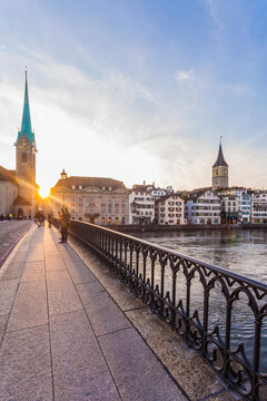 Switzerland, Canton of Zurich, Zurich, Minster Bridge at sunset with riverside buildings in background