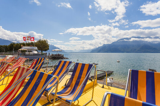 Switzerland, Canton of Vaud, Vevey, Empty deckchairs on shore of Lake Geneva