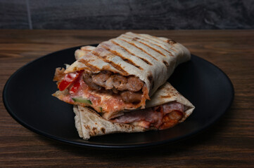 shawarma on a black plate in a cut