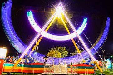 Long Exposure of a pirate ship at a fairground with light trails