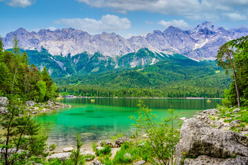 Fototapeta na wymiar Eibsee lake with Zugspitze mountain in the background. Beautiful landscape scenery with paradise beach and clear blue water in German Alps - Garmisch Partenkirchen, Grainau - Bavaria, Germany, Europe.