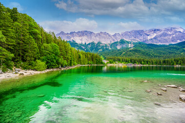 Naklejka na ściany i meble Eibsee lake with Zugspitze mountain in the background. Beautiful landscape scenery with paradise beach and clear blue water in German Alps - Garmisch Partenkirchen, Grainau - Bavaria, Germany, Europe.