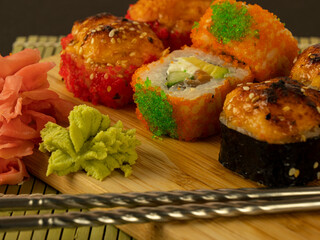 Different rolls on a wooden board, on a black background