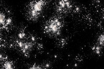 Scattered flour on a black background.