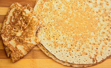 Stack of homemade pancakes on wood cooking board