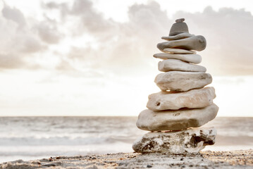 A composition of stacked stones on the beach. Focus on the right