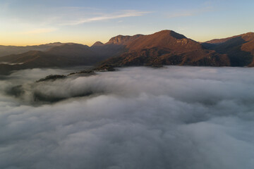 Fototapeta premium Flying through the clouds at dawn above the jumping lake in Rieti