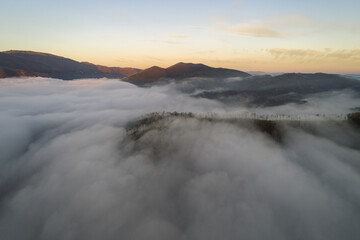 Flying through the clouds at dawn above the jumping lake in Rieti