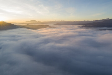 Fototapeta na wymiar Flying through the clouds at dawn above the jumping lake in Rieti