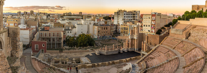 CARTAGENA, SPAIN - December 2, 2017: Aerial panoramic view of port city Cartagena in Spain with famous roman amphitheater. Beautiful sunset over the mountains. Wide angle lens panorama