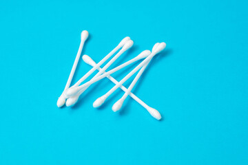 Sticks for cleaning ears on a blue background.