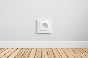 New electrical socket isolated on gray wall. Renovated studio apartment power supply background. Brown wooden floor. Empty copy space white plastic power outlet.