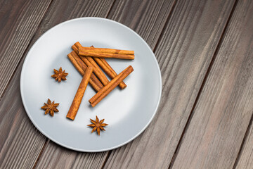 Cinnamon sticks and star anise in gray ceramic plate