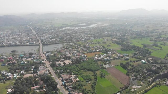 Aerial view of Gingee City, Sangarabarani River and hill landscape in background during foggy and cloudy day in India.