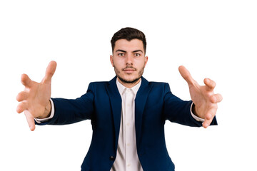 Young brown-haired businessman on a white background with outstretched hands towards the camera