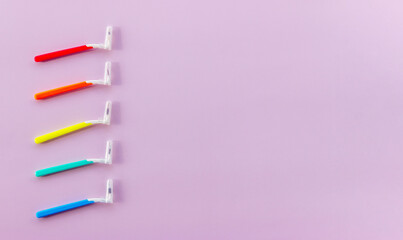 Multi-Coloured brushes for cleaning braces and interdental space on a pink background. Oral hygiene is the to successful treatment. Top view. Flat lay. Copy space for text.