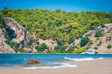 Turquoise waves of the sea on a sandy beach of turtles in the Dalyan Mugla region, Turkey.