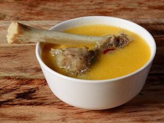 Mutton Paya soup, traditional South Asian food.cooked with various spices served over a rustic wooden background, selective focus