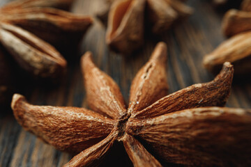Macro photo of anise stars on wooden background