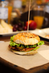 Burgers with lettuce, cutlet and tomatoes. Burgers in the restaurant. Burgers close up. Fast food, wrong food. Fat. Obesity