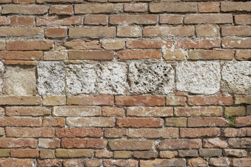 White rock frames in the middle of a red brick wall, Bricks cracked and urban, background with space for text and no person, horizontal format