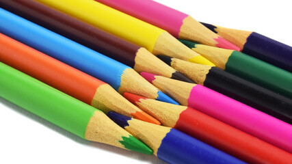 Fototapeta premium colored pencils arranged head to head isolated on a white background. copy paste space