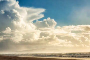 Obraz premium Big fluffy clouds above seashore