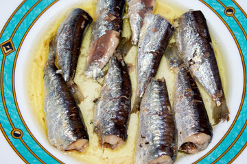 Aegean sea sardines in vegetable oil, in a plate. top view, selective focus
