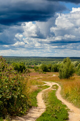the road through the field before a tunderstorm