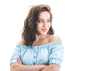 Young woman with crossed arms posing and looking to side. Beautiful girl standing, half length. Copy space. Isolated on white background