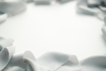 grey and peach silk ribbons on a light background . sewing theme . the view from the top . space for text.