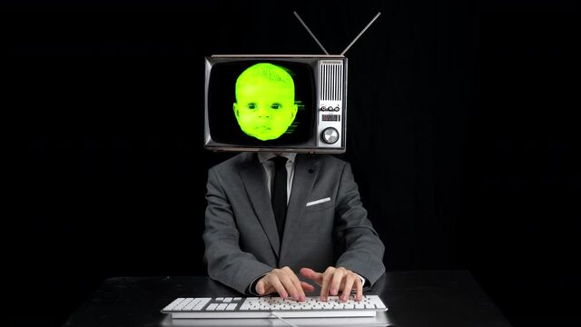 Man using keyboard with television on head with baby's face