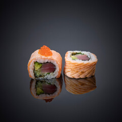 Japanese rolls on a gray-black background.
