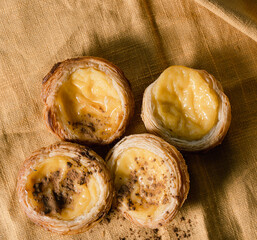 Pasteis de nata on yellow backdrop