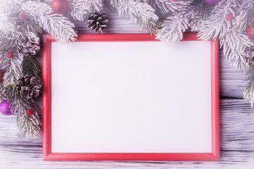 Mock up of red frame with blank white paper sheet in Christmas decoration