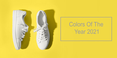 Banner with grey female gumshoes on yellow background. View from above. Space for text. Trendy color Ultimate Grey and Illuminating of the 2021 year. Space for text.