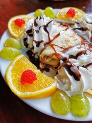 Fruit omelette with whipped cream.