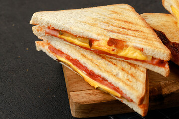 Triangle toasted sandwich on wooden board close up