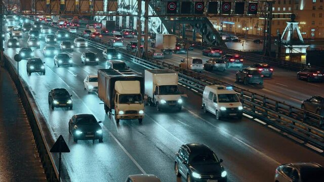 Car traffic on the Andreevsky bridge over the Moscow river at night in Moscow, Russia 27.11.2020