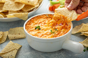 Buffalo chicken dip served with chips and fresh vegetables - obrazy, fototapety, plakaty