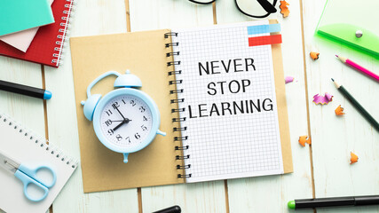 Never stop learning memo written on a notebook with pen