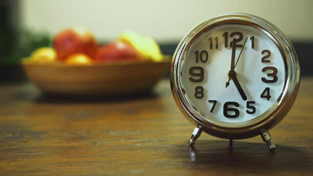 The clock shows five o'clock in the morning.