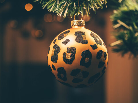 Golden leopard print glass Christmas tree ornament. Holiday decorations.